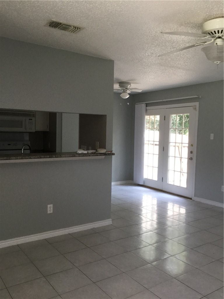 13409 Saddlebrook Trail, Unit A Austin, TX 78729 - Photo 6 of 21 a view of a kitchen with a sink and a microwave