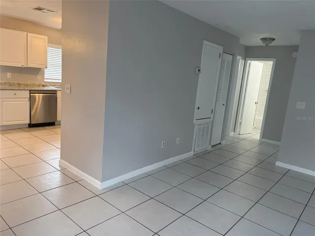 a view of a kitchen with white cabinets