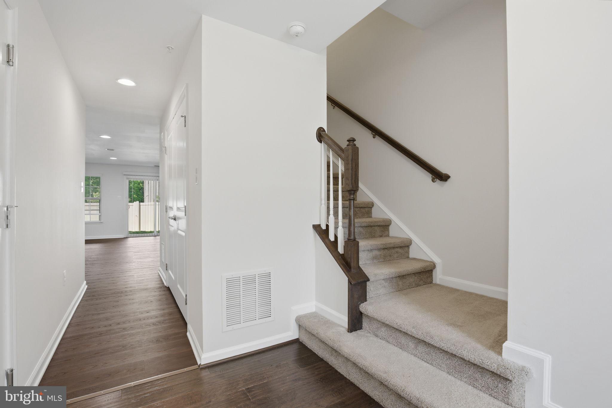 2784 Fredericksburg Road Hanover, MD 21076 - Photo 7 of 60 a view of a hallway with wooden floor and staircase