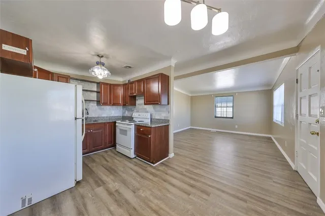 a view of kitchen and kitchen with wooden floor