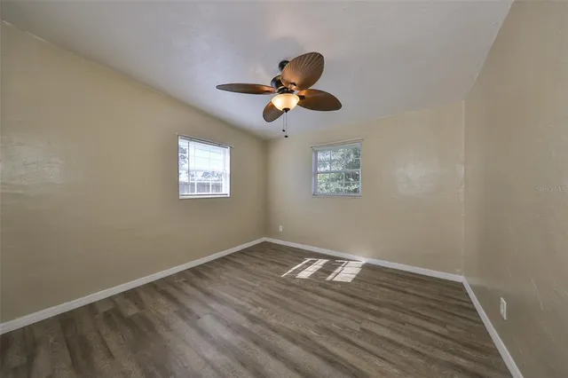 a view of room with hardwood floor and ceiling fan