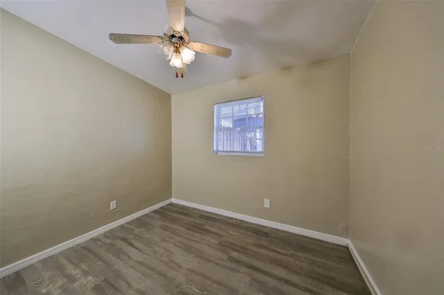 a view of an empty room with a fan