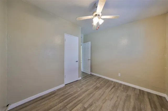 an empty room with wooden floor