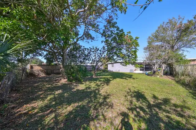 a backyard of a house with yard and trampoline