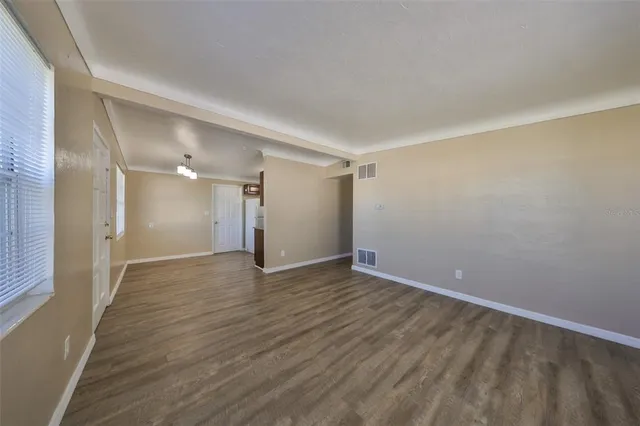 a view of an empty room and wooden floor