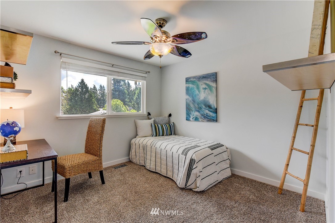 21828 Meridian Avenue South Bothell, WA 98021 - Photo 17 of 31 a living room with a bed furniture and a window