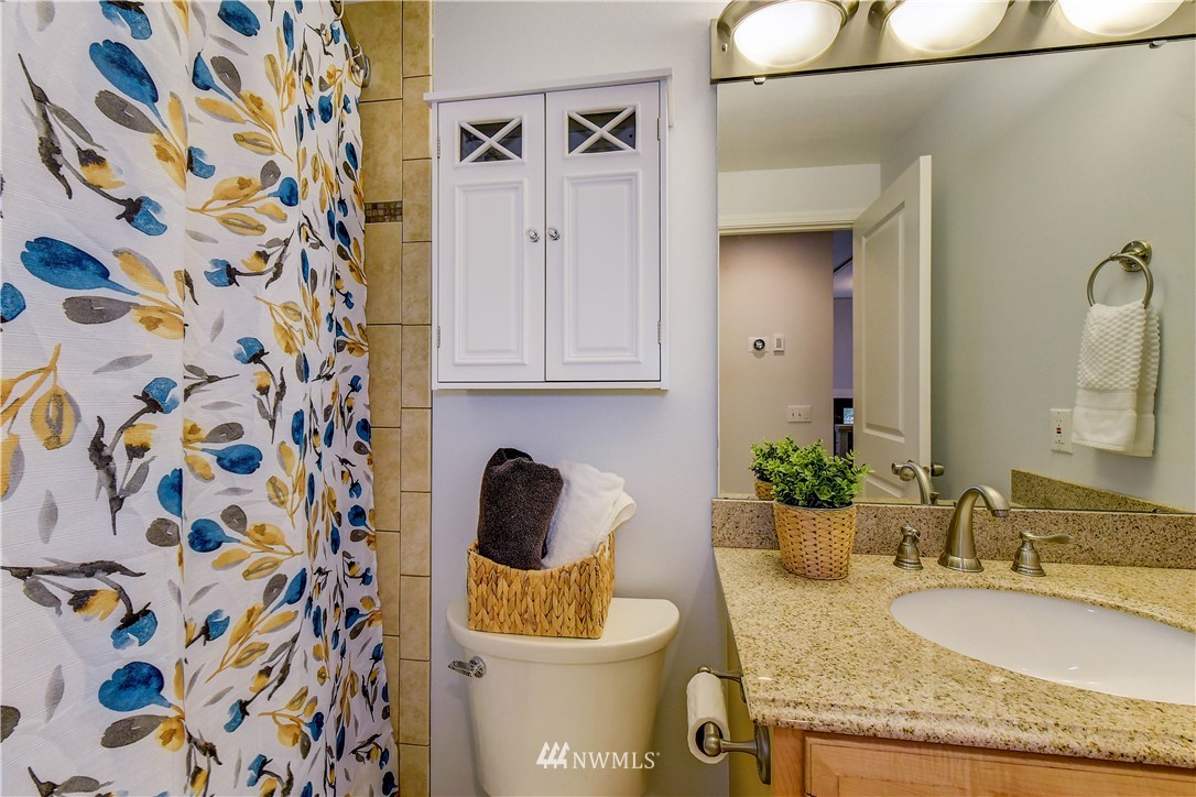 21828 Meridian Avenue South Bothell, WA 98021 - Photo 19 of 31 a bathroom with a granite countertop sink and a mirror