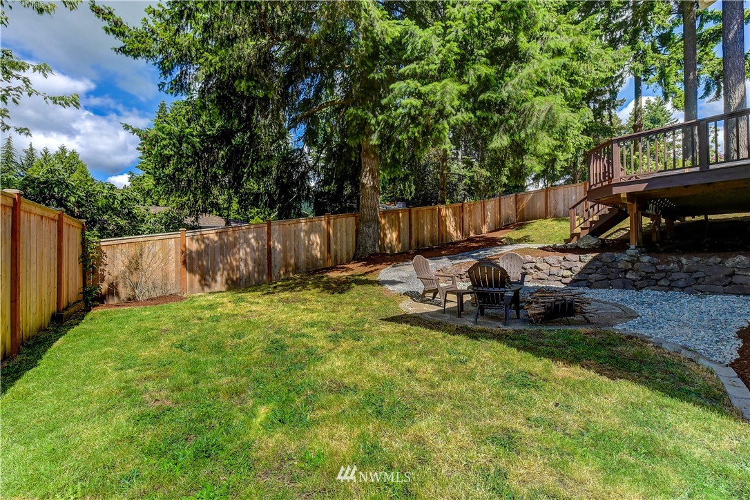 21828 Meridian Avenue South Bothell, WA 98021 - Photo 27 of 31 a view of a backyard with table and chairs and a fire pit