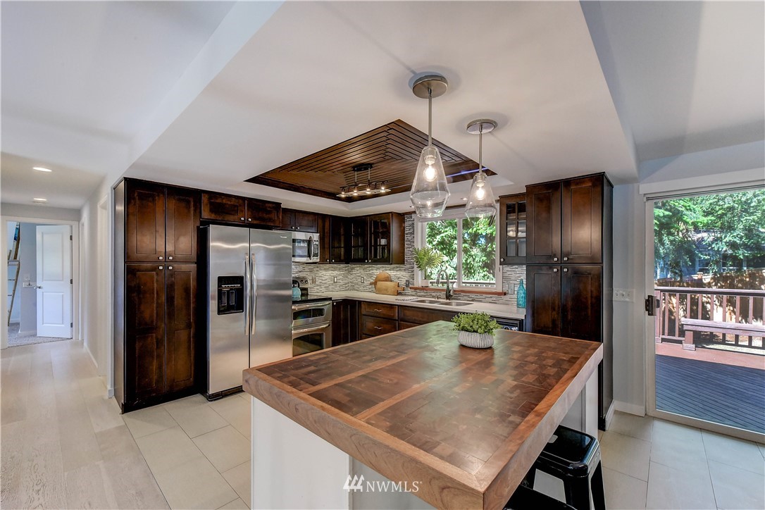 21828 Meridian Avenue South Bothell, WA 98021 - Photo 10 of 31 a kitchen with stainless steel appliances granite countertop a sink a stove and a refrigerator