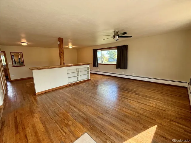 an entryway with floor to ceiling windows and fireplace
