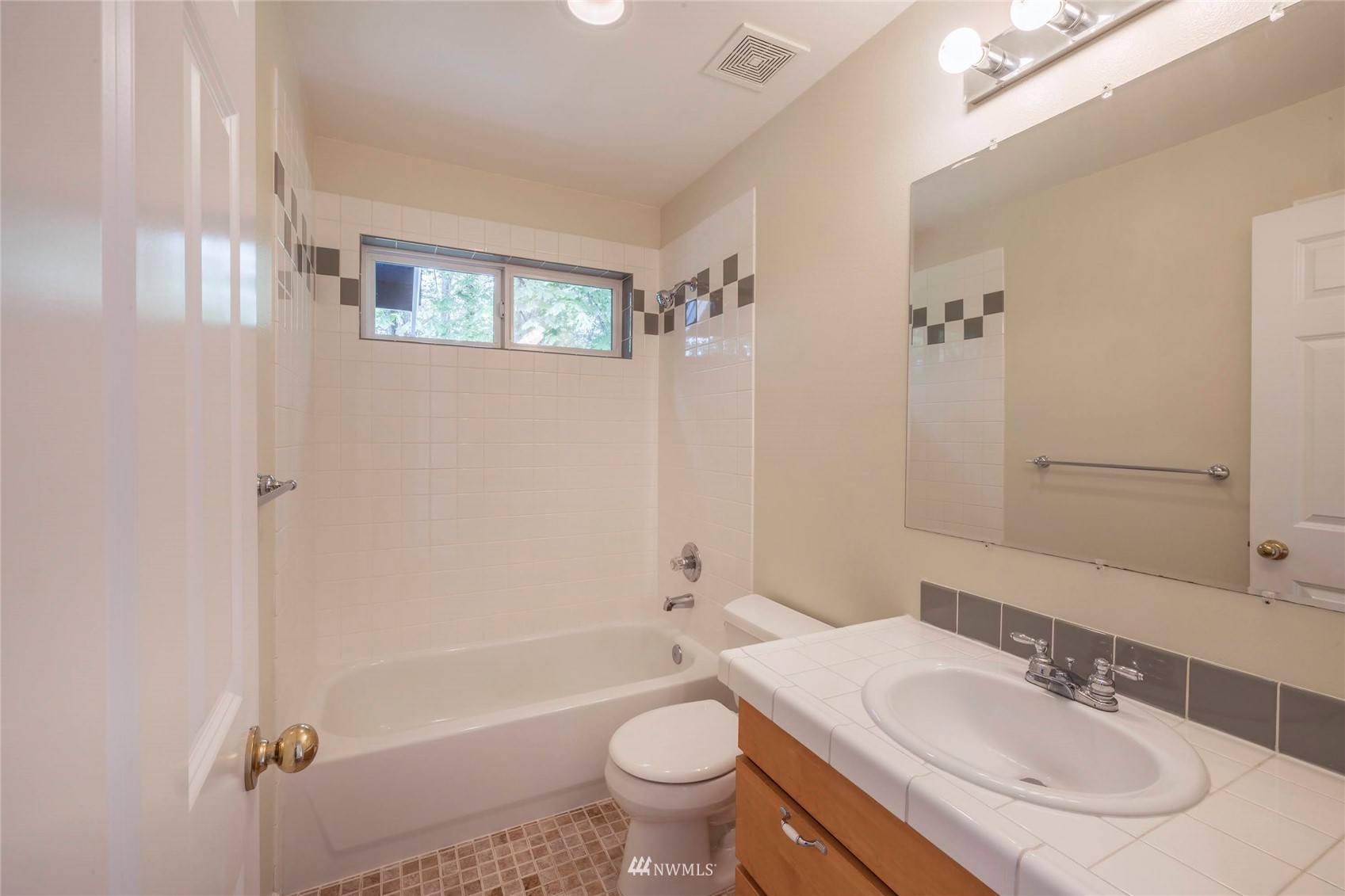 2802 Tracyton Beach Road Northwest Bremerton, WA 98310 - Photo 20 of 40 a bathroom with a granite countertop sink a toilet a mirror and shower