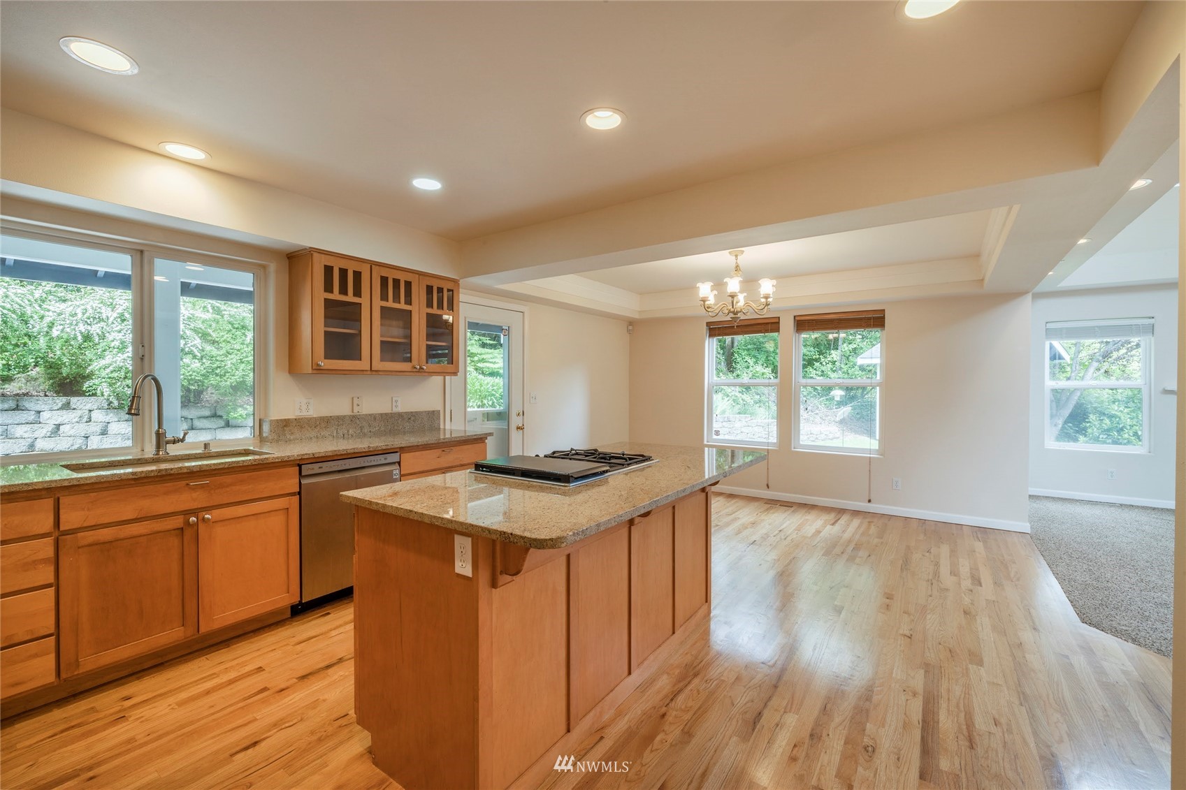 2802 Tracyton Beach Road Northwest Bremerton, WA 98310 - Photo 8 of 40 a kitchen with stainless steel appliances granite countertop wooden floors and sink