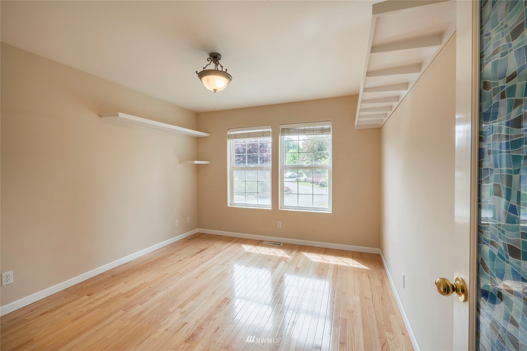 2802 Tracyton Beach Road Northwest Bremerton, WA 98310 - Photo 10 of 40 a view of an empty room with wooden floor and a window