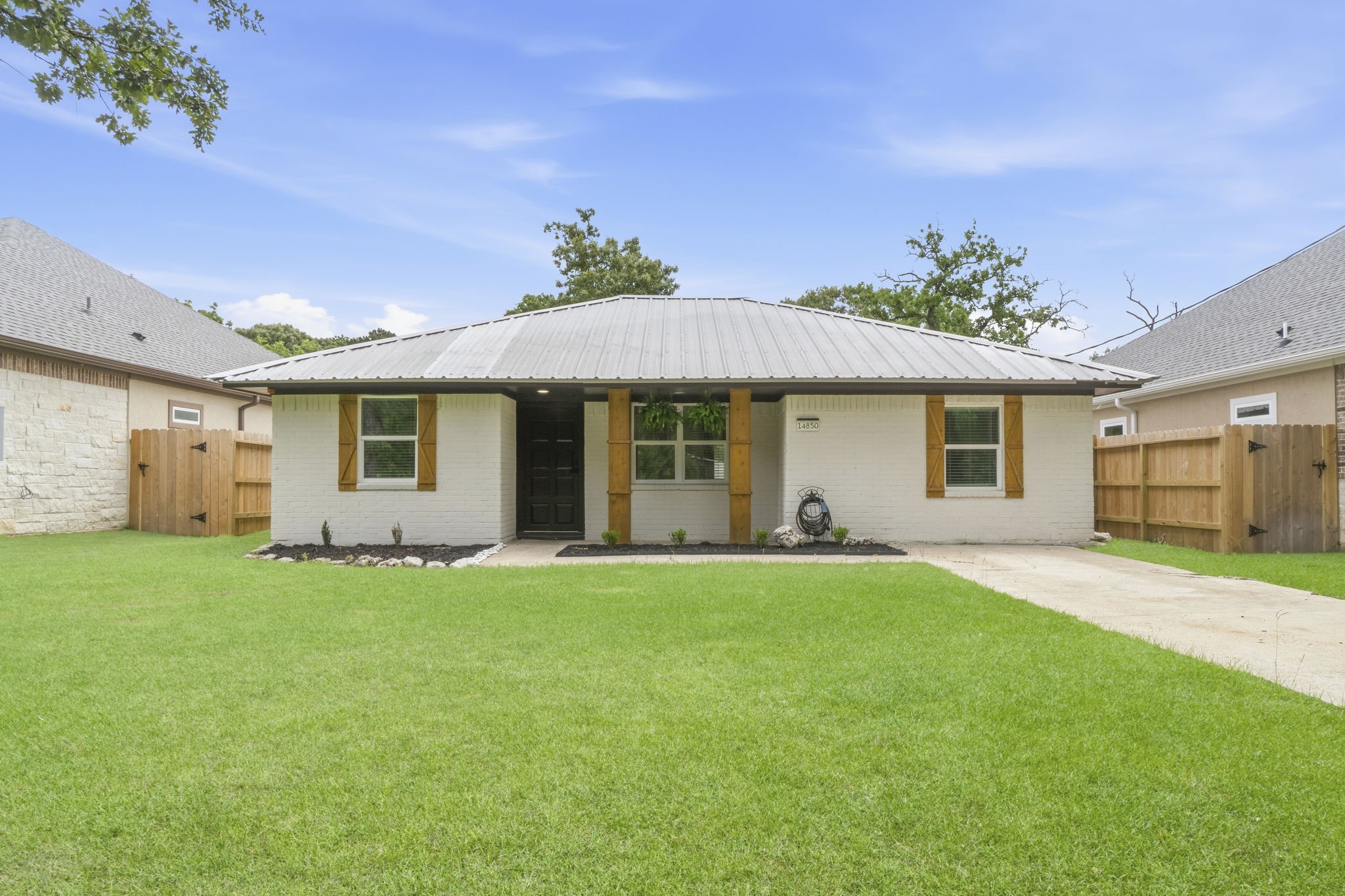 14850 Coaltown Road Willis, TX 77378 - Photo 1 of 41 Beautifully remodeled home with charming curb appeal featuring a durable metal roof, fresh landscaping, cedar shutters and columns, and a spacious front yard.