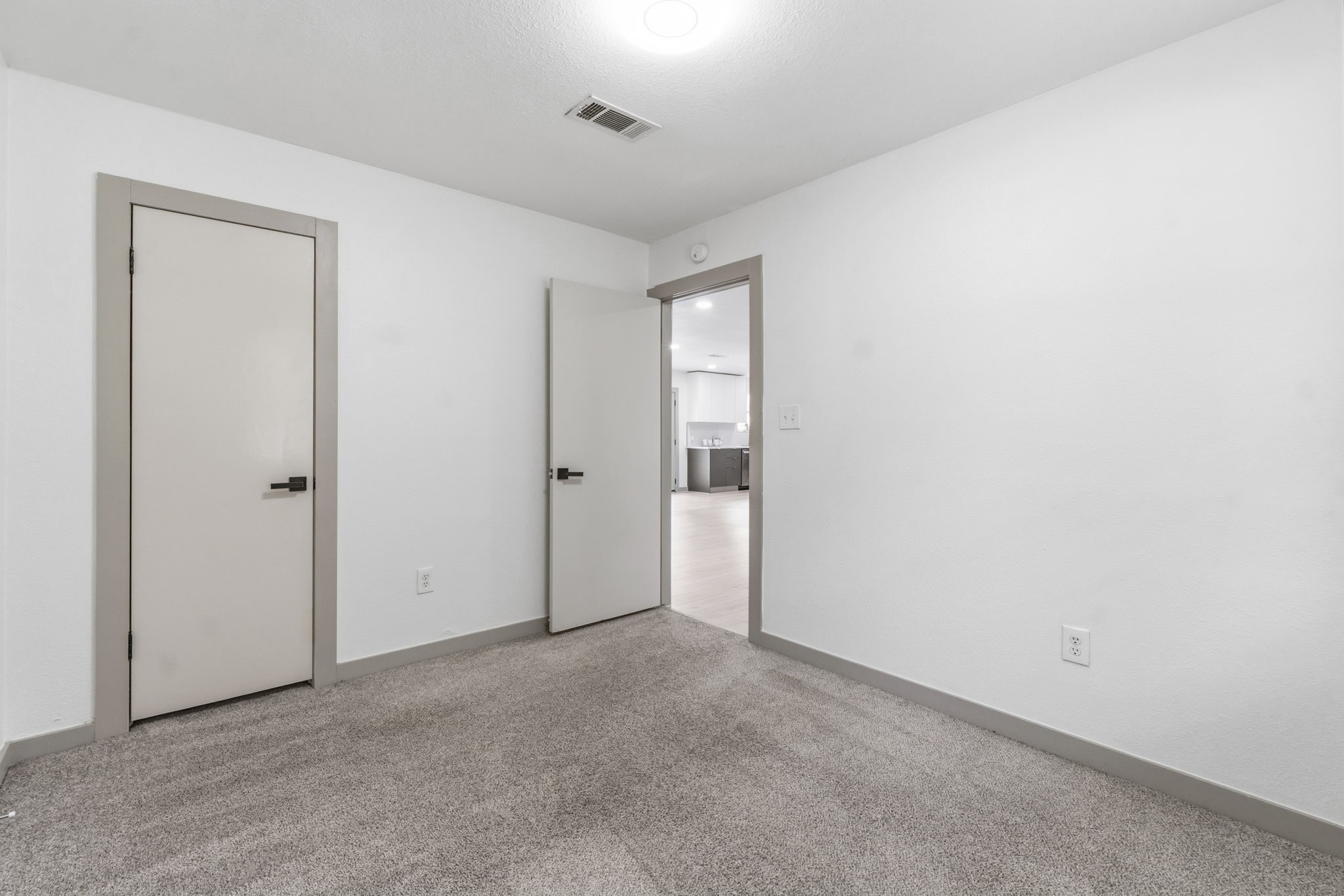14850 Coaltown Road Willis, TX 77378 - Photo 16 of 41 Comfortable secondary bedroom with modern finishes, updated flooring transitions, and easy access to the main living area.