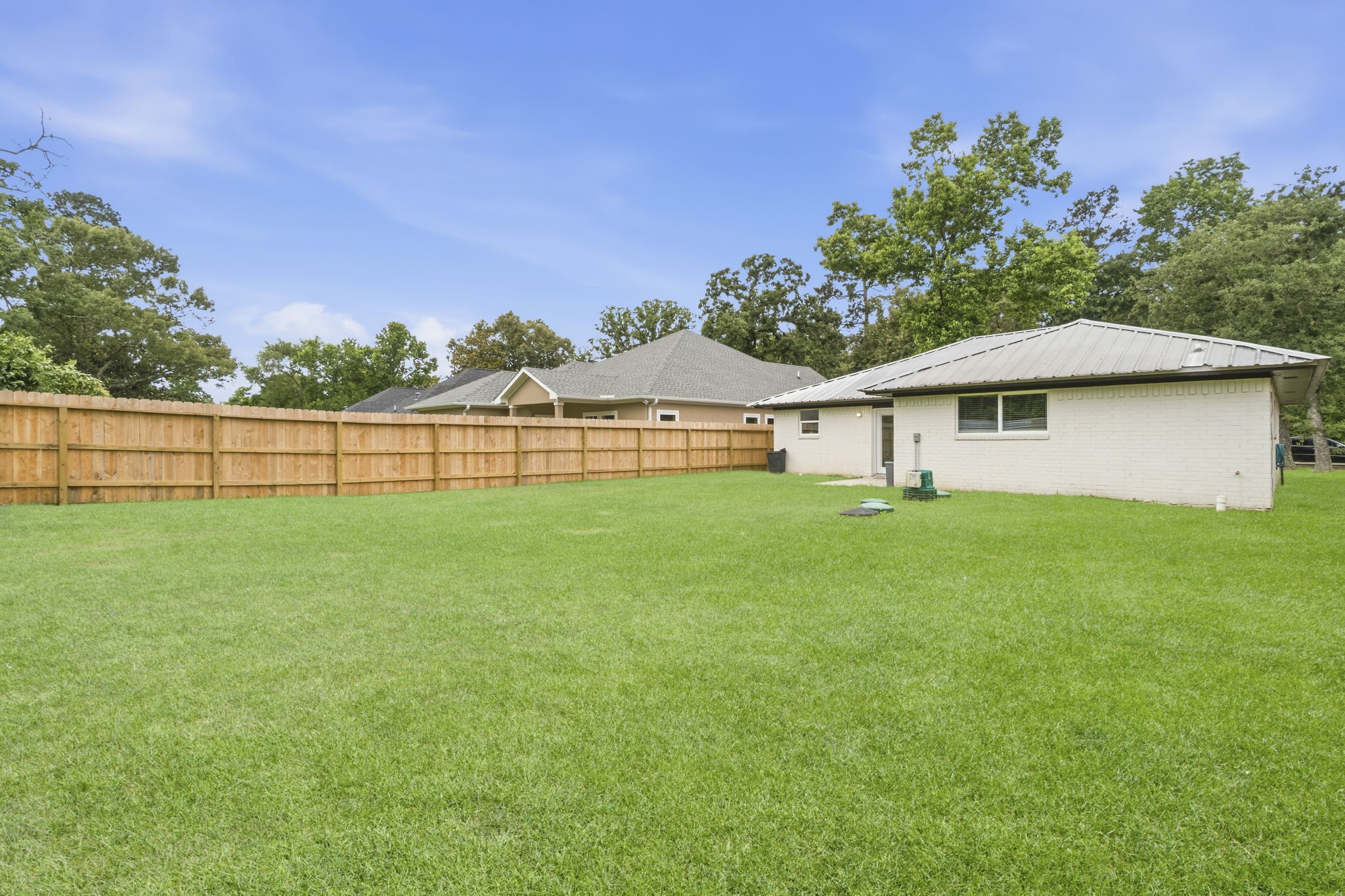 14850 Coaltown Road Willis, TX 77378 - Photo 30 of 41 Oversized backyard with mature tree-lined surroundings providing a peaceful setting and plenty of usable outdoor space.