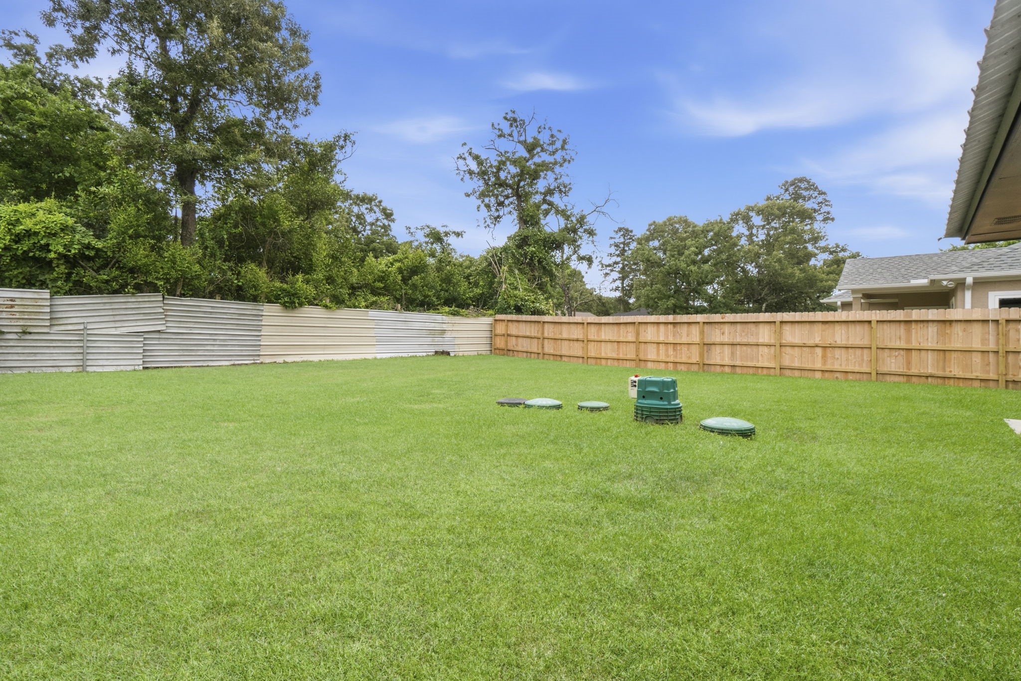 14850 Coaltown Road Willis, TX 77378 - Photo 31 of 41 Wide open backyard with lush green lawn, ideal for entertaining, gardening, or creating your dream outdoor retreat.