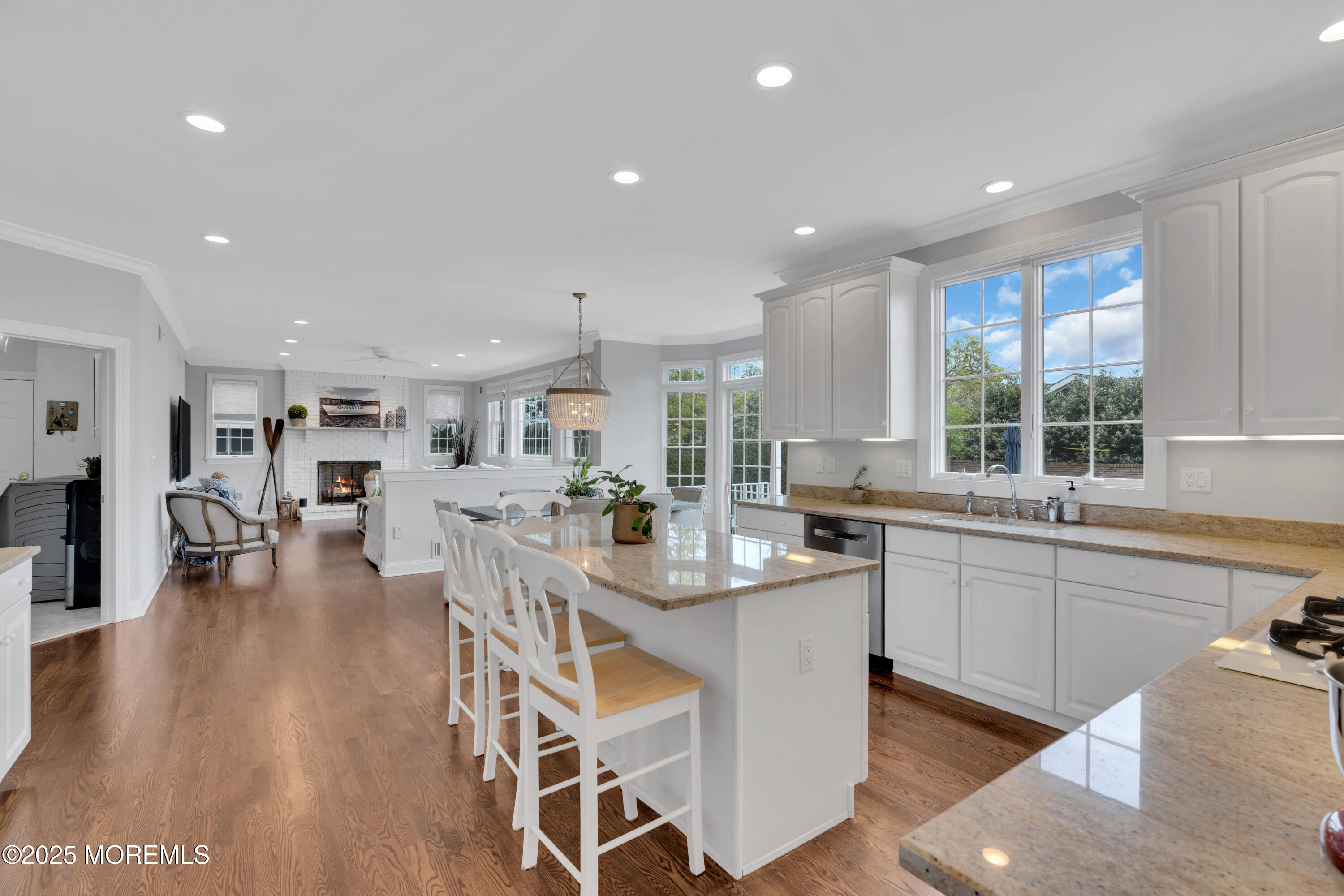 201 Jersey Avenue Spring Lake, NJ 07762 - Photo 11 of 29 a kitchen with stainless steel appliances granite countertop a refrigerator a sink dishwasher and a dining table with wooden floor