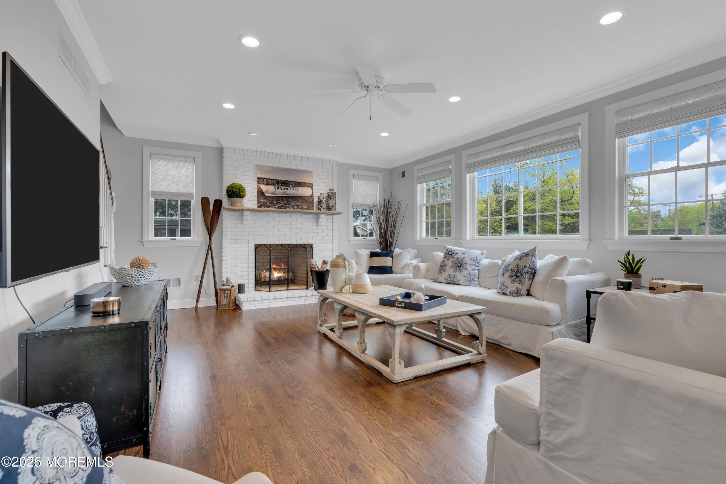201 Jersey Avenue Spring Lake, NJ 07762 - Photo 14 of 29 a living room with furniture a fireplace a flat screen tv and a large window