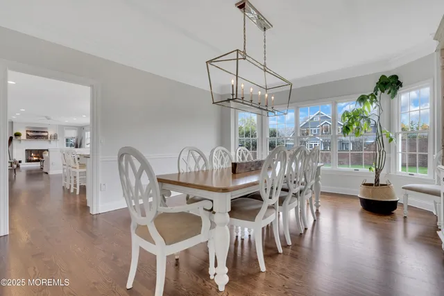 a dining room with furniture window and wooden floor