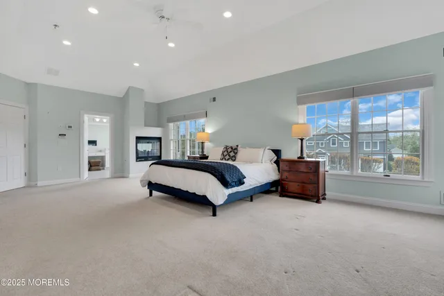 a spacious bedroom with a bed and a large window