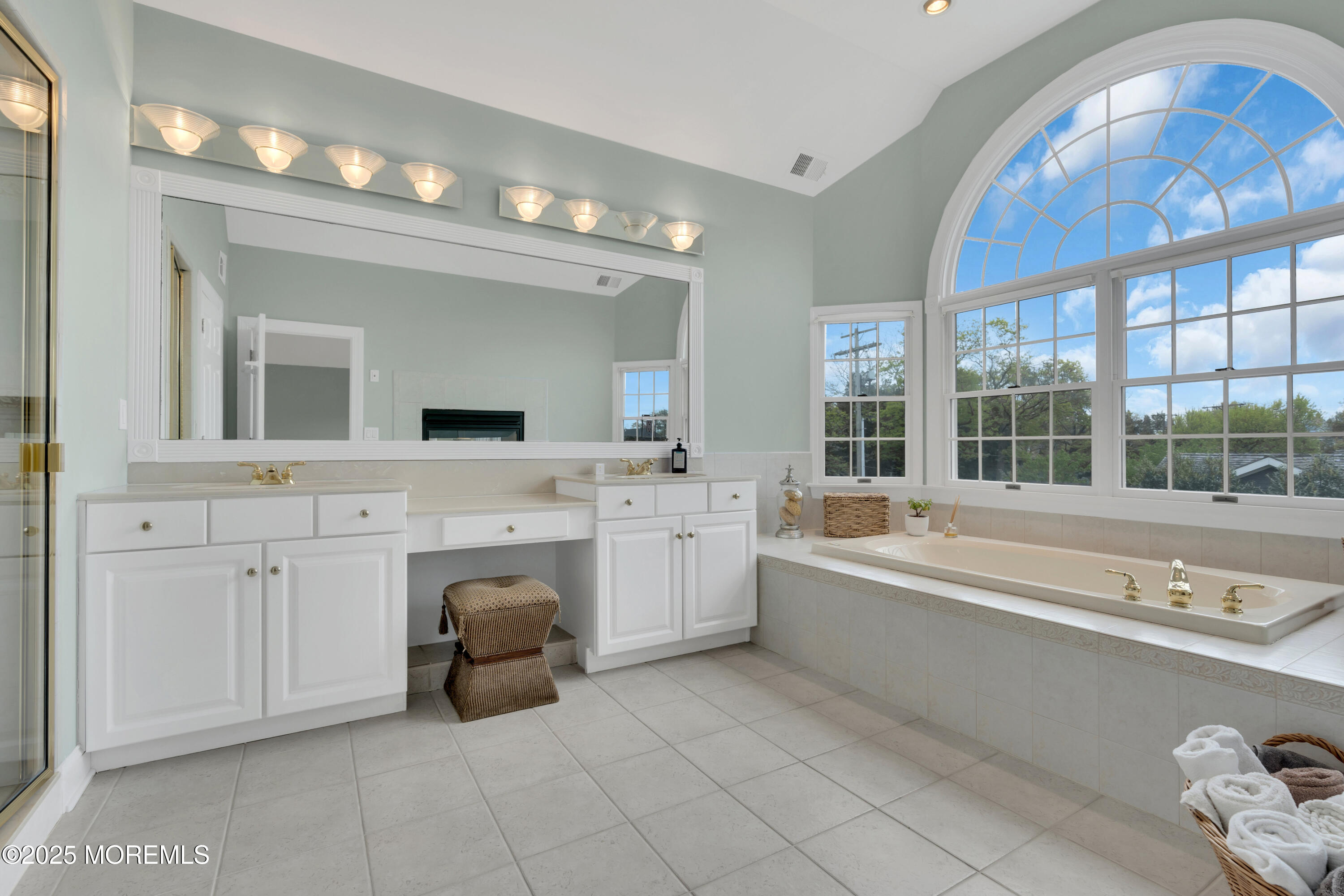 201 Jersey Avenue Spring Lake, NJ 07762 - Photo 20 of 29 a spacious bathroom with a tub double sink window and mirror