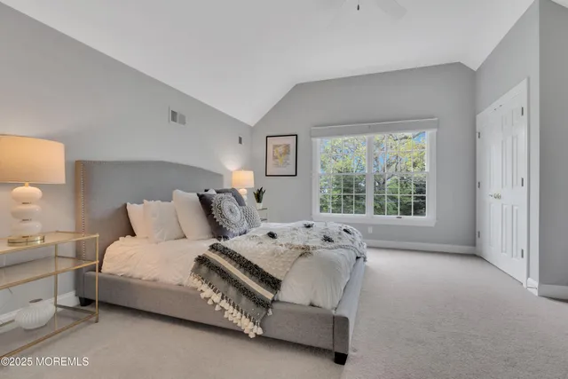a bedroom with a bed and a large window