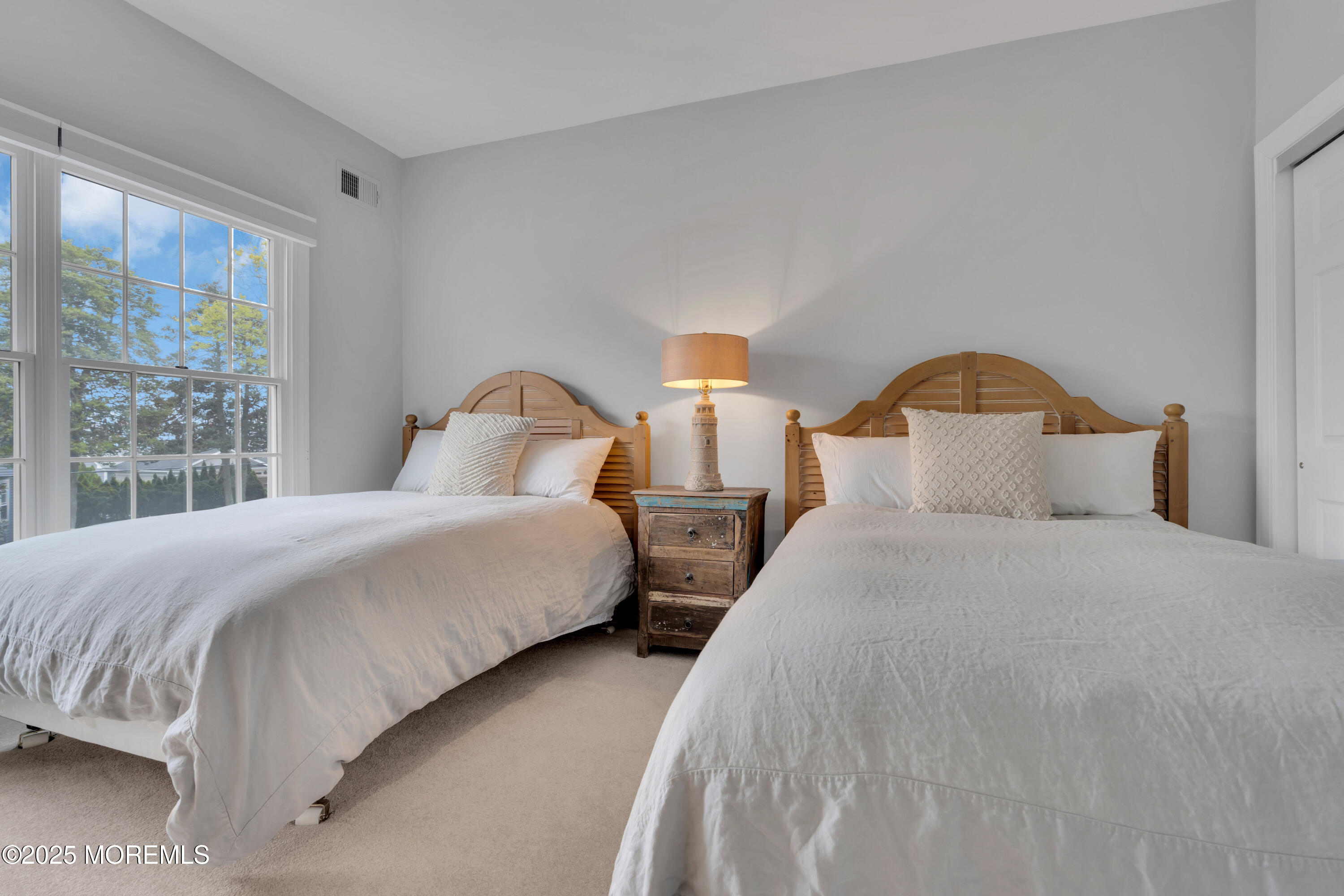 201 Jersey Avenue Spring Lake, NJ 07762 - Photo 25 of 29 a bedroom with two beds and a window