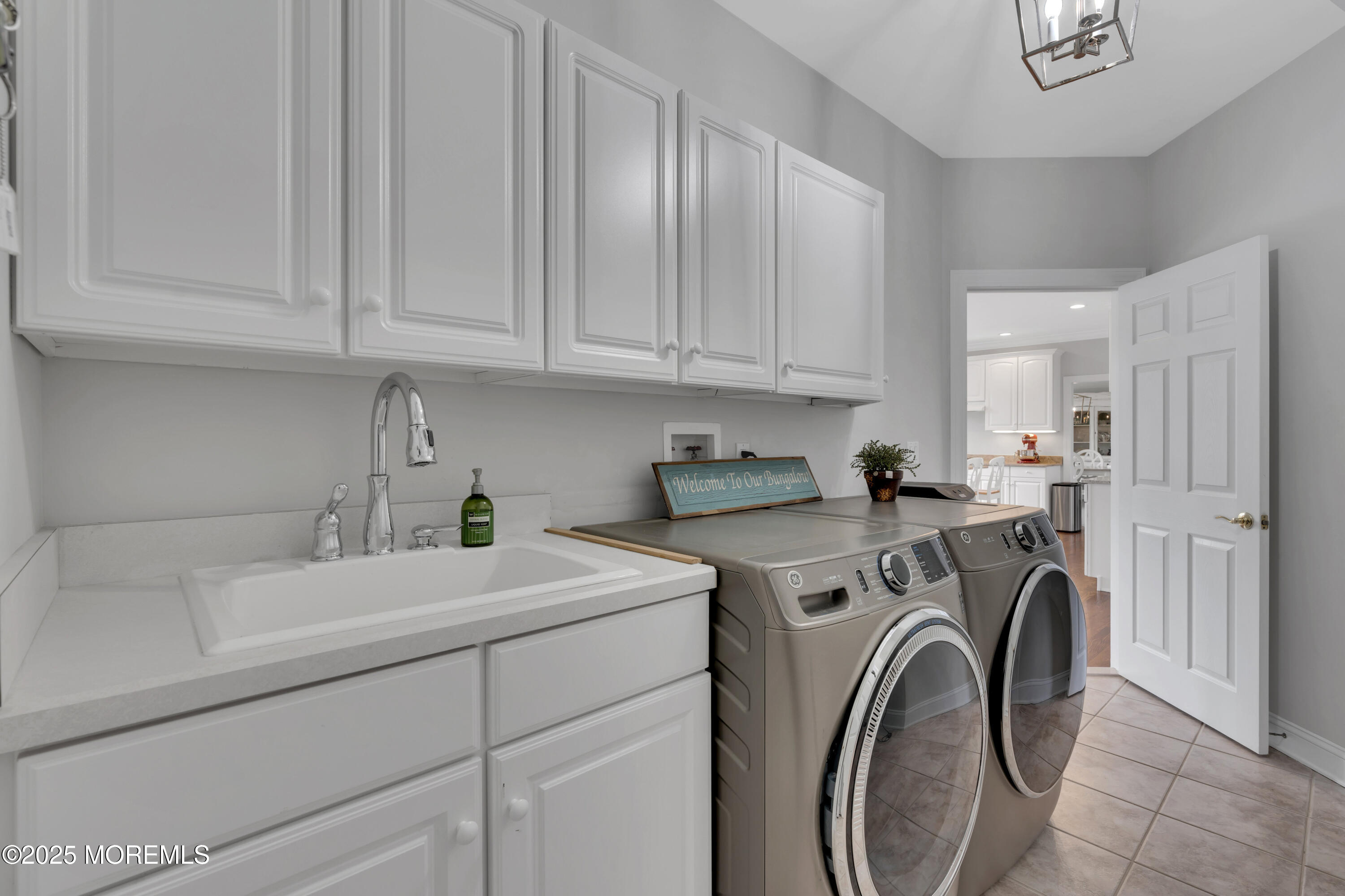 201 Jersey Avenue Spring Lake, NJ 07762 - Photo 26 of 29 a view of a storage and utility room with washer and dryer