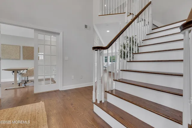 a view of staircase with white walls and a window