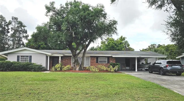 a front view of a house with a garden and patio