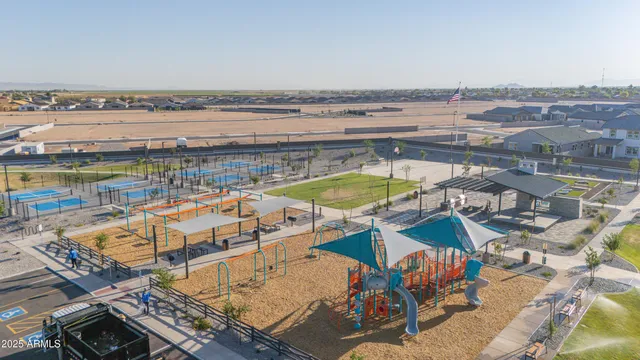 an aerial view of a swimming pool with outdoor seating