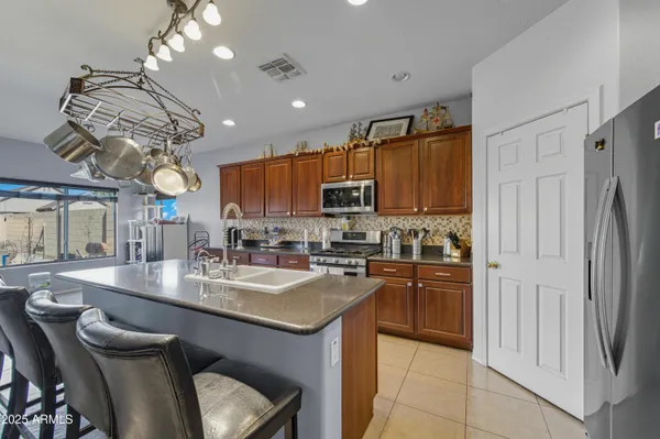 a living room with furniture a chandelier and a dining table