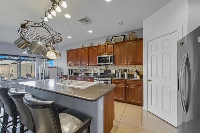 a living room with furniture a chandelier and a dining table