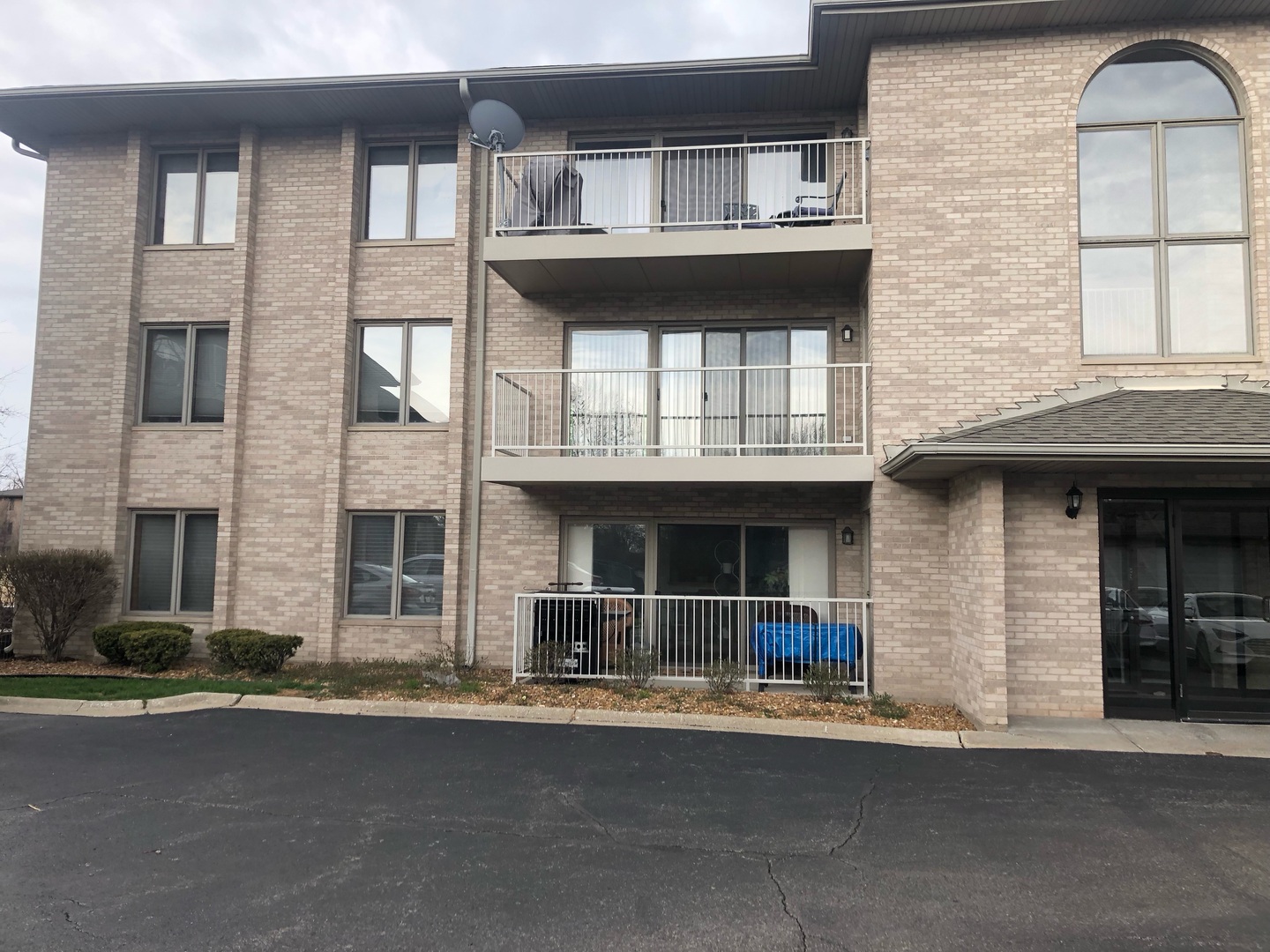 1053 Ashley Court North, Unit 2B Lockport, IL 60441 - Photo 1 of 4 a front view of a house with a garden