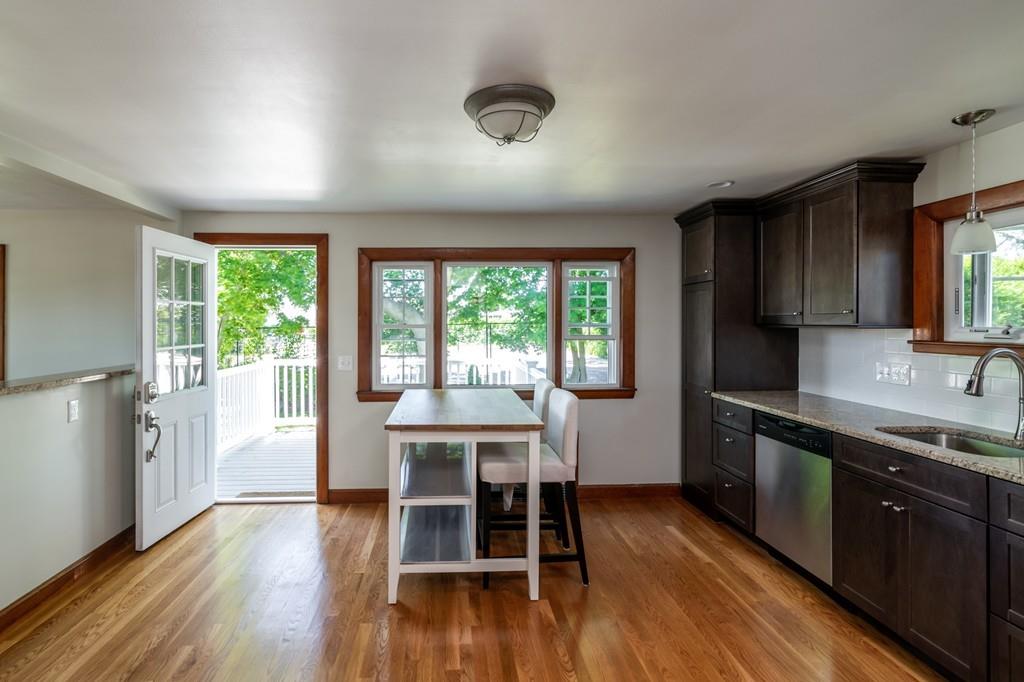 122 Edgewater Road Hull, MA 02045 - Photo 11 of 24 a kitchen with a table chairs sink and cabinets