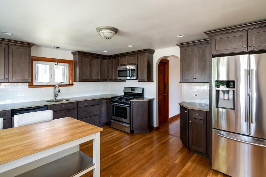 122 Edgewater Road Hull, MA 02045 - Photo 10 of 24 a kitchen with granite countertop stainless steel appliances and wooden cabinets