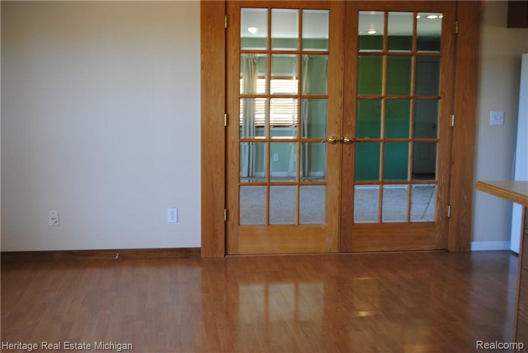 4354 Crandall Road Howell, MI 48855 - Photo 4 of 17 Notice the shining wood floor of the dining room! View the great room through the French doors!