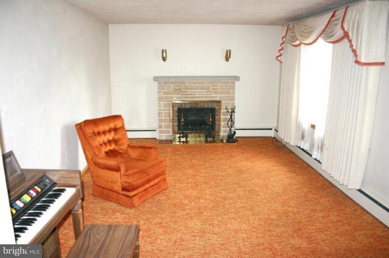 4206 Hunter Road South Hampstead, MD 21074 - Photo 4 of 4 a view of an empty room with a fireplace and a window