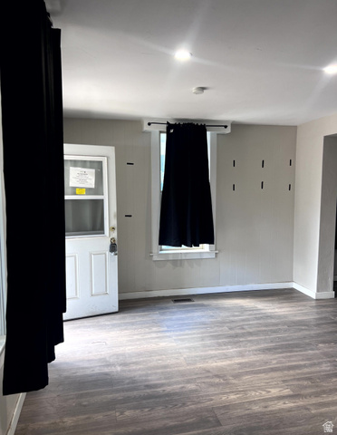 3161 Adams Avenue Ogden, UT 84403 - Photo 7 of 17 Spacious room featuring wood-finish flooring, recessed lighting, and a white paneled entry door with a storm door