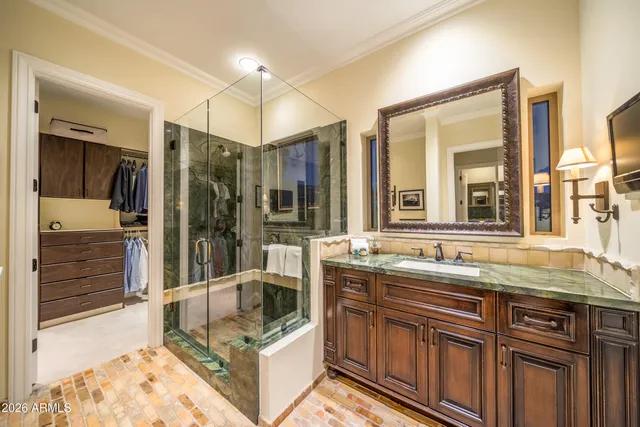a bathroom with a tub sink shower and mirror