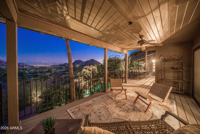 a view of a balcony with chairs and a table
