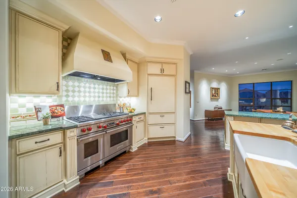 a kitchen with stainless steel appliances a stove a sink and a refrigerator