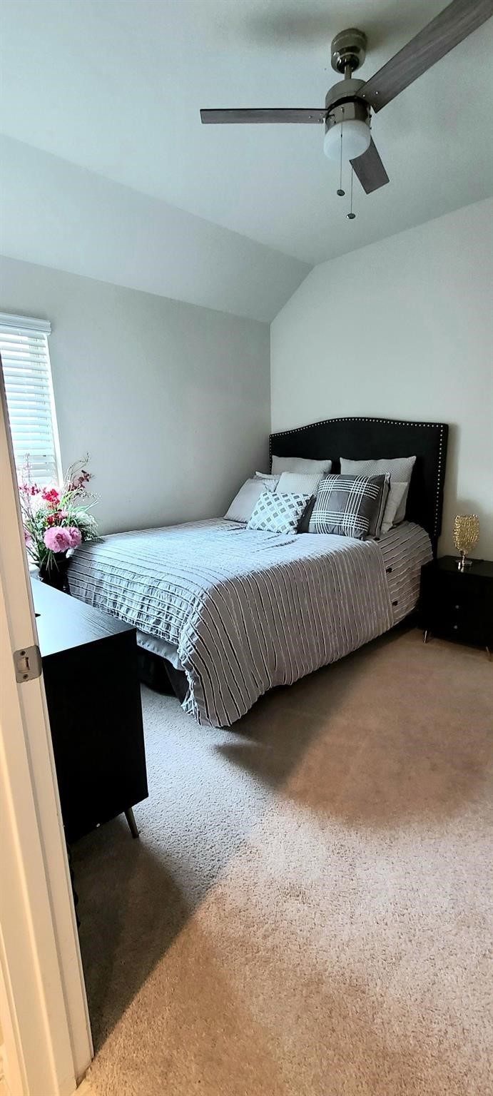 2710 Little Caney Way Conroe, TX 77301 - Photo 13 of 25 a bedroom with a bed and a lamp on the dresser