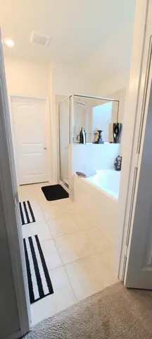 a bedroom with a bed and a mirror