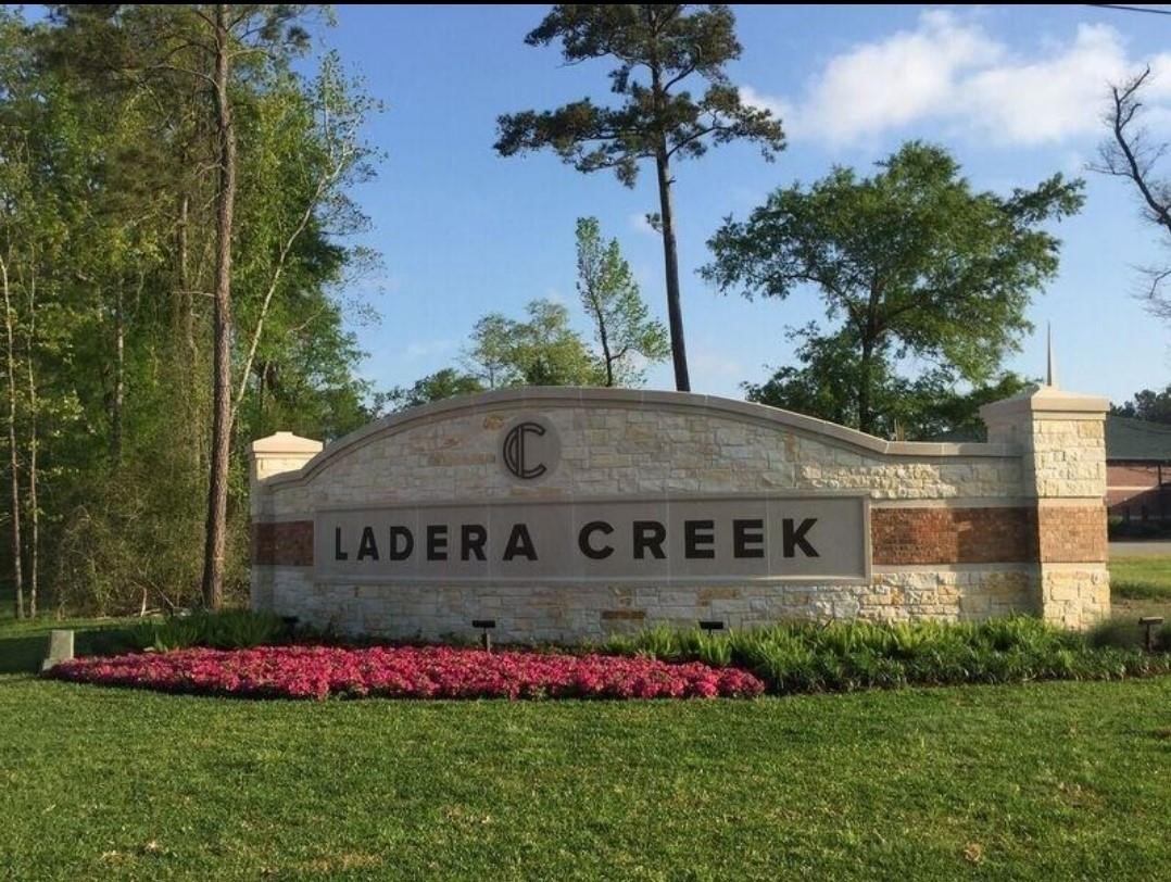 2710 Little Caney Way Conroe, TX 77301 - Photo 20 of 25 a view of an house with backyard space and garden