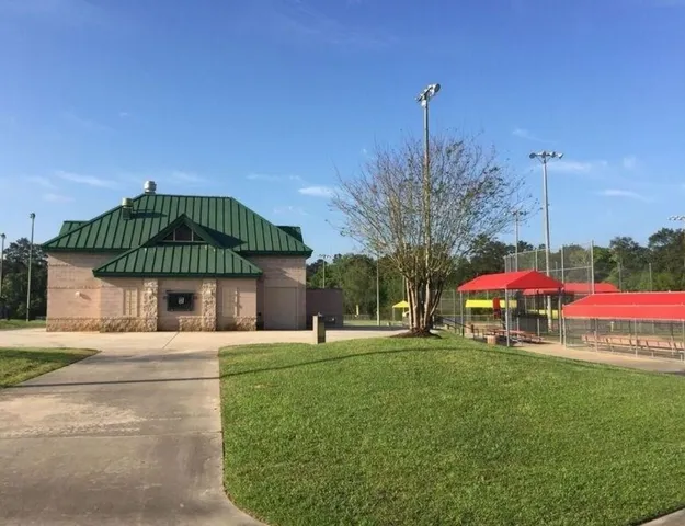 a swimming pool with yard in front of it