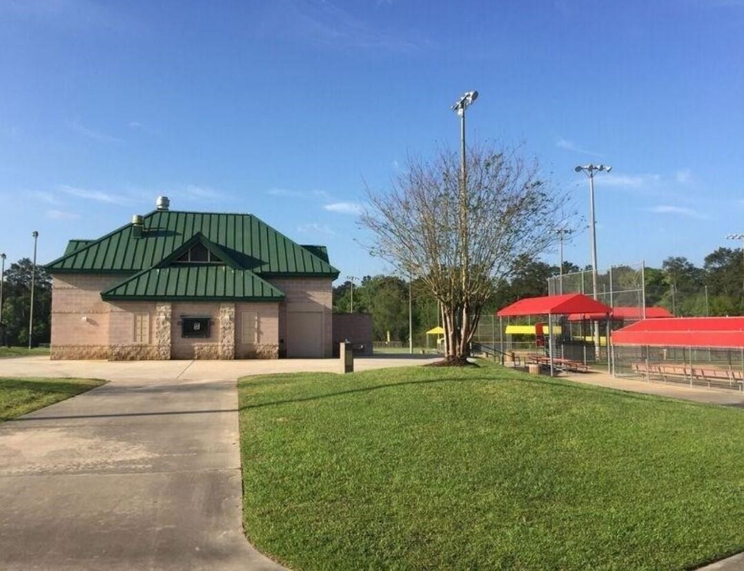 2710 Little Caney Way Conroe, TX 77301 - Photo 22 of 25 a swimming pool with yard in front of it