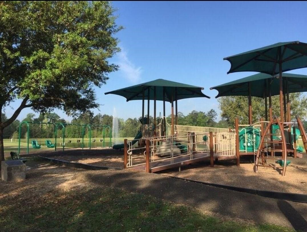 2710 Little Caney Way Conroe, TX 77301 - Photo 23 of 25 a view of a table and chairs under an umbrella