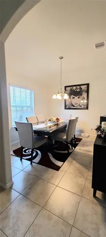 a living room with furniture a rug and a painting on the wall